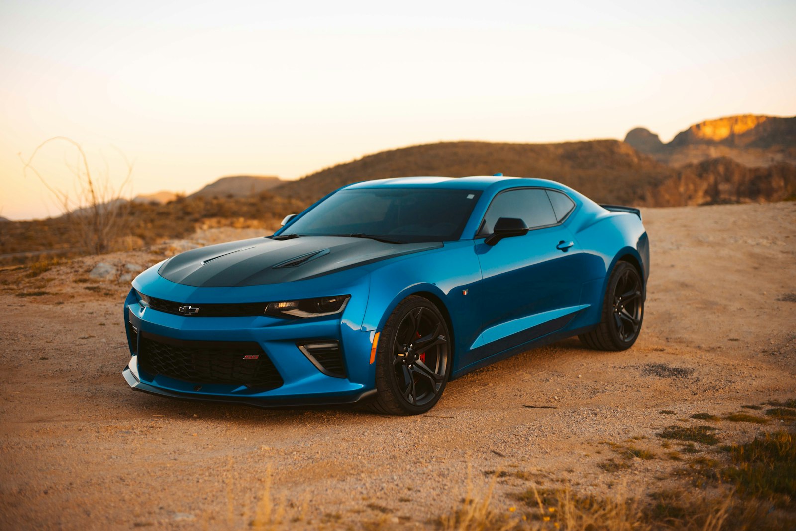 Glossy luxury car with open driver door at golden hour, showing clean exterior and interior