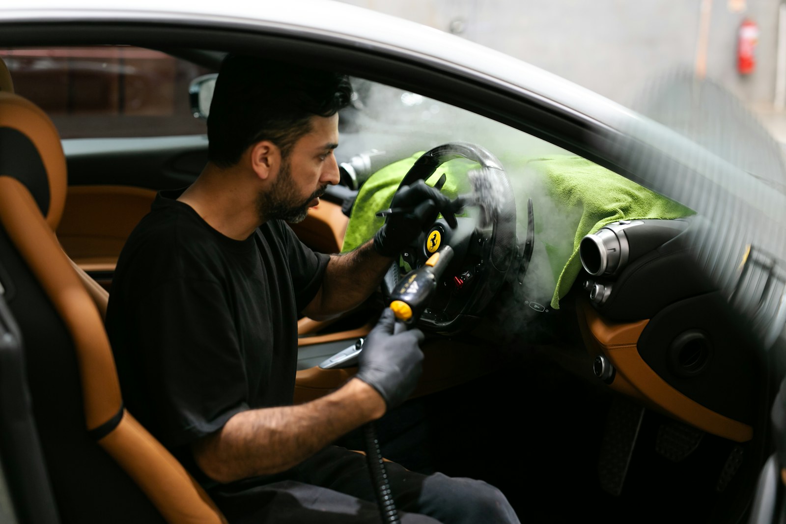 Vacuum cleaning the dashboard area of a clean car interior